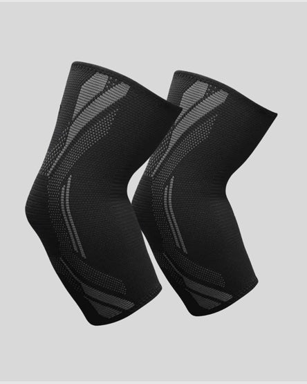 A pair of black knee compression sleeves with gray textured pattern accents, displayed against a solid light gray background.
